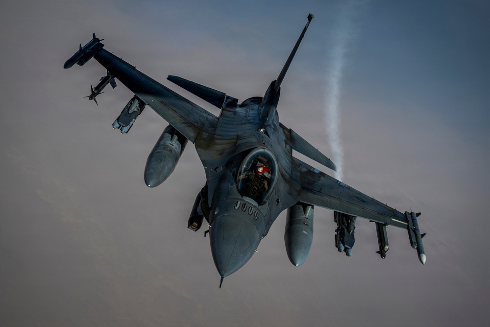 KC135 refuels F16s during routine patrol