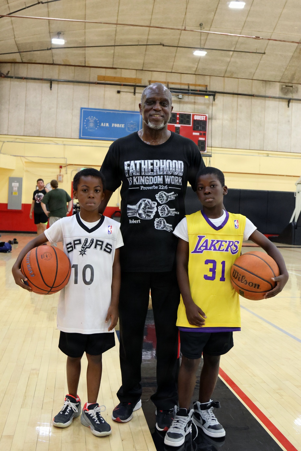 U.S. Marines and local community members participate in a pickup basketball game