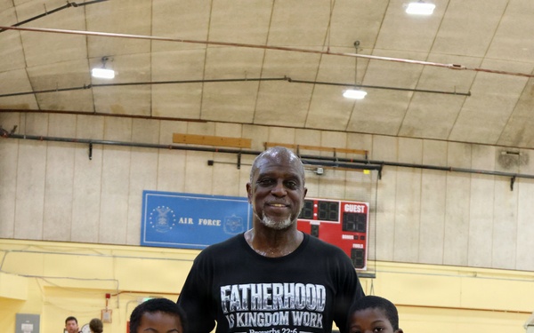 U.S. Marines and local community members participate in a pickup basketball game