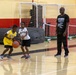 U.S. Marines and local community members participate in a pickup basketball game