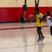 U.S. Marines and local community members participate in a pickup basketball game