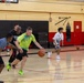 U.S. Marines and local community members participate in a pickup basketball game