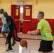 U.S. Marines and local community members participate in a pickup basketball game
