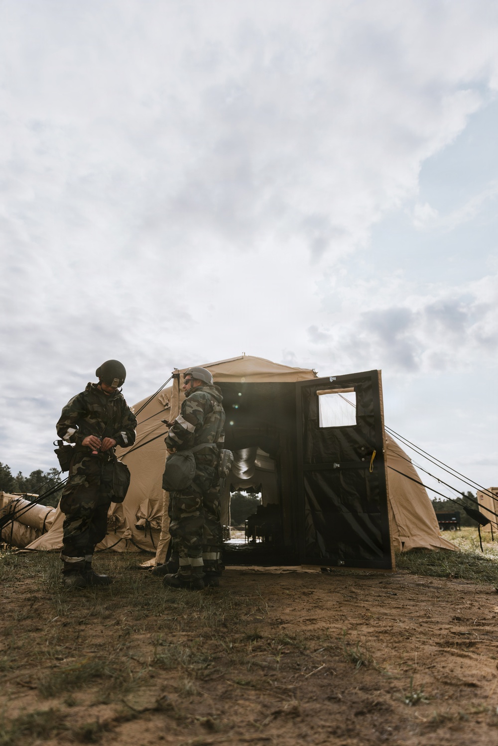 Airmen from the 131st Civil Engineer Squadron and the 139th Civil Engineer Squadron perform tasks in MOPP gear