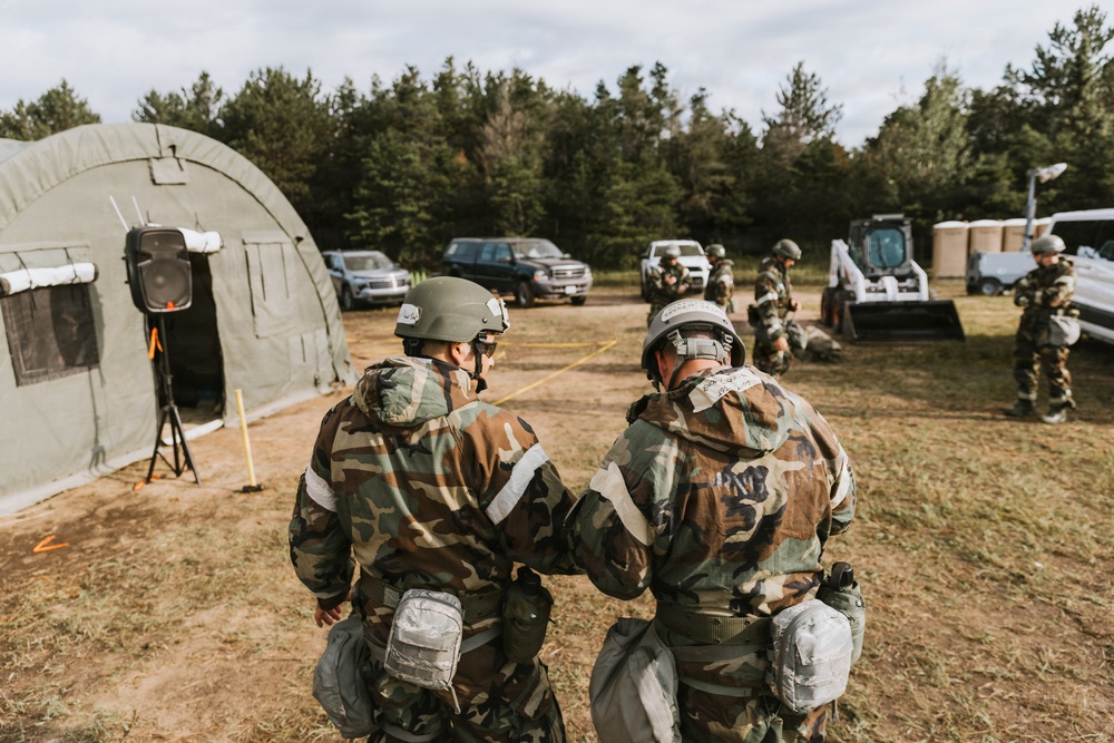 Airmen from the 131st Civil Engineer Squadron and the 139th Civil Engineer Squadron perform tasks in MOPP gear