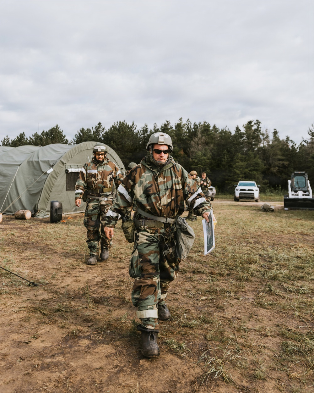 Airmen from the 131st Civil Engineer Squadron and the 139th Civil Engineer Squadron perform tasks in MOPP gear