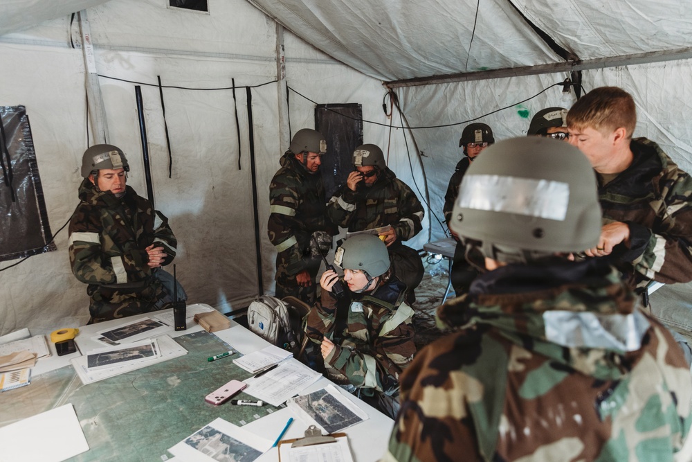 Airmen from the 131st Civil Engineer Squadron and the 139th Civil Engineer Squadron perform tasks in MOPP gear
