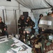 Airmen from the 131st Civil Engineer Squadron and the 139th Civil Engineer Squadron perform tasks in MOPP gear