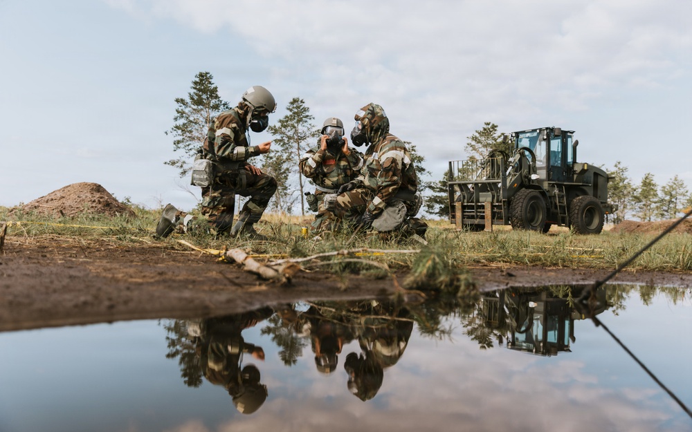 Airmen from the 131st Civil Engineer Squadron and the 139th Civil Engineer Squadron perform tasks in MOPP gear