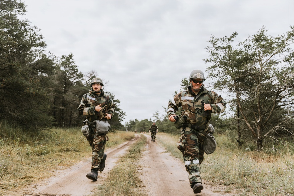 Airmen from the 131st Civil Engineer Squadron and the 139th Civil Engineer Squadron perform tasks in MOPP gear