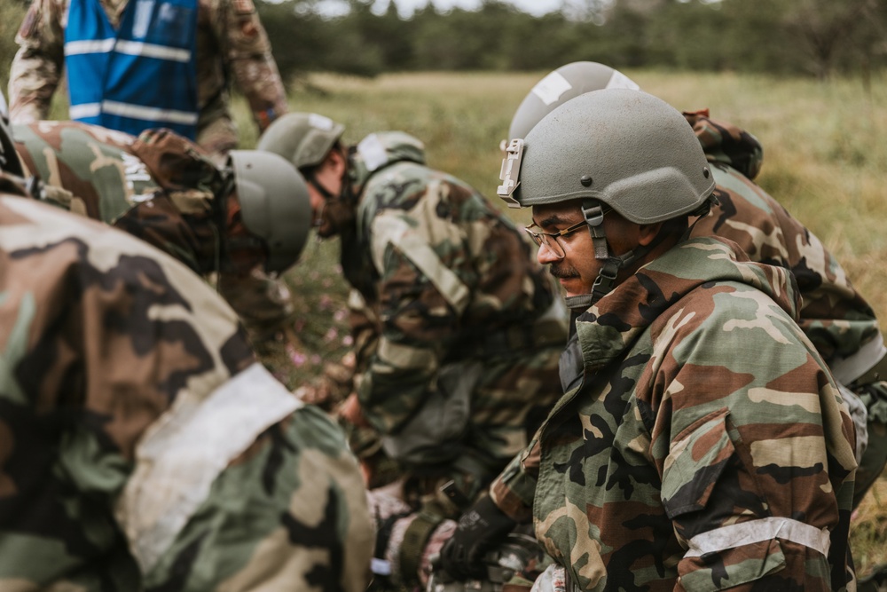 Airmen from the 131st Civil Engineer Squadron and the 139th Civil Engineer Squadron perform tasks in MOPP gear