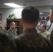A group of military personnel from what appears to be the U.S. Army and Republic of Korea (ROK) Army are gathered in an indoor office or briefing room. The individuals are engaged in conversation, suggesting a joint meeting, briefing, or exchange visit. A unit insignia on the wall partially reads 'Blackhawks' indicating a U.S. Army aviation or combat unit.