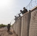 591st Engineer Company places Concertina Wire on top of HESCO barriers at NDA 2