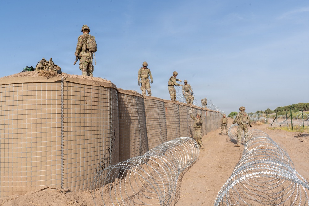 591st Engineer Company places Concertina Wire on top of HESCO barriers at NDA 2
