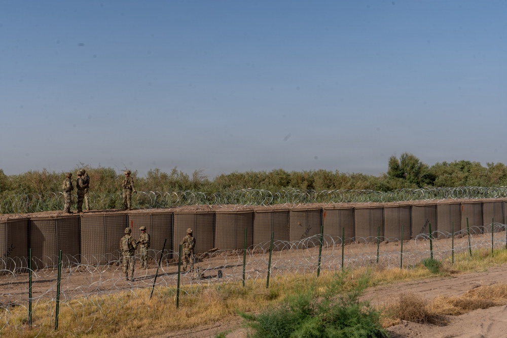 591st Engineer Company places Concertina Wire on top of HESCO barriers at NDA 2