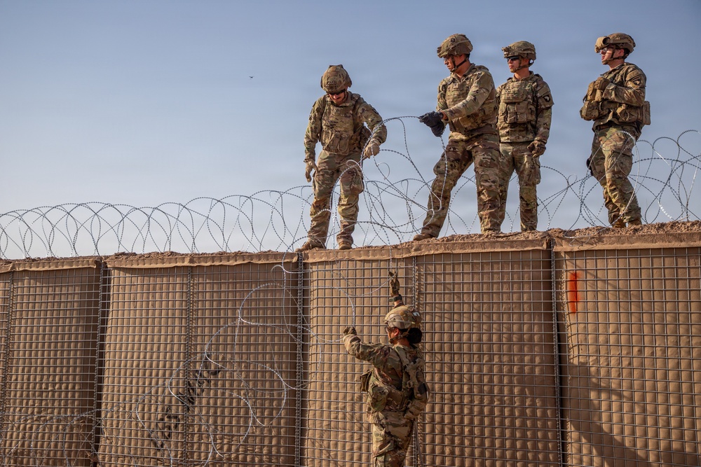 591st Engineer Company places Concertina Wire on top of HESCO barriers at NDA 2