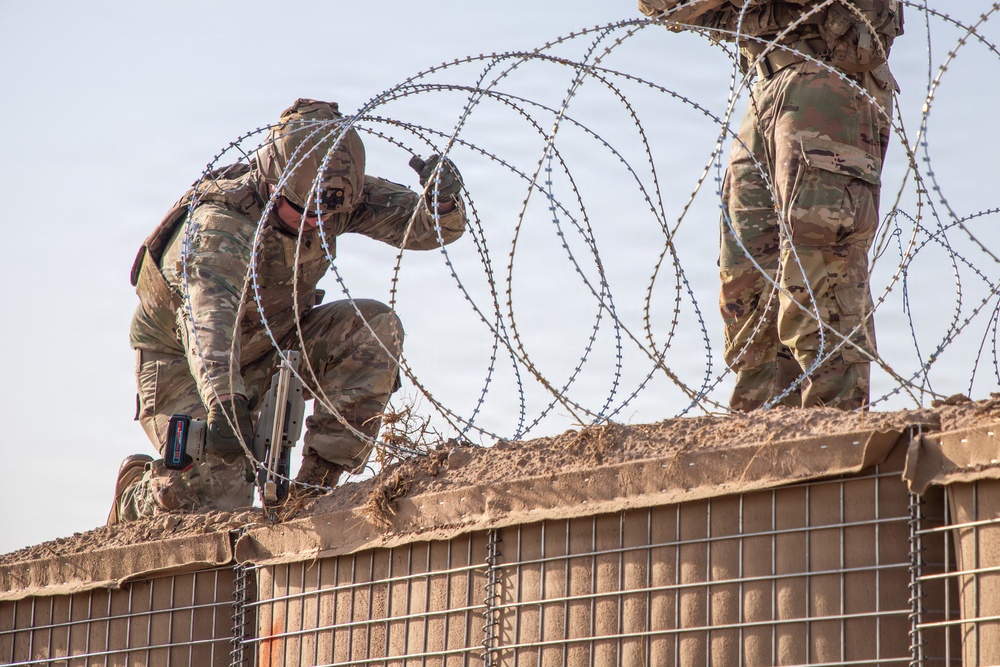 591st Engineer Company places Concertina Wire on top of HESCO barriers at NDA 2