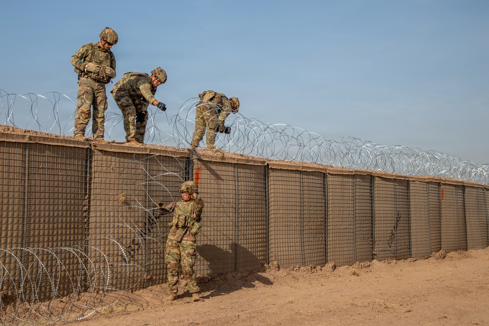 591st Engineer Company places Concertina Wire on top of HESCO barriers at NDA 2