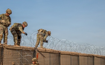 591st Engineer Company places Concertina Wire on top of HESCO barriers at NDA 2