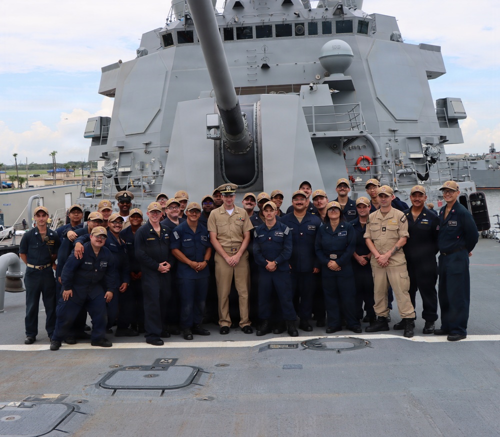 Captain Mary Hays, Commanding Officer, USS Ted Stevens (DDG 128), promotes Weapons Officer, LT Zachary Wasson, to the rank of Lieutenant Commander.