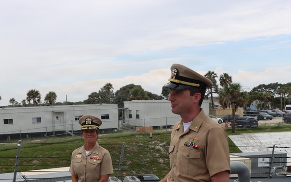Captain Mary Hays, Commanding Officer, USS Ted Stevens (DDG 128), promotes Weapons Officer, LT Zachary Wasson, to the rank of Lieutenant Commander.