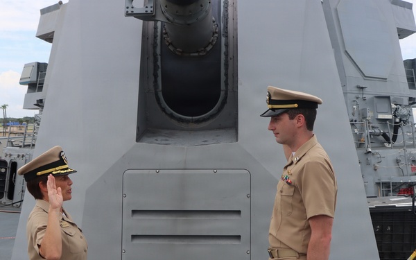 Captain Mary Hays, Commanding Officer, USS Ted Stevens (DDG 128), promotes Weapons Officer, LT Zachary Wasson, to the rank of Lieutenant Commander.