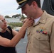 Captain Mary Hays, Commanding Officer, USS Ted Stevens (DDG 128), promotes Weapons Officer, LT Zachary Wasson, to the rank of Lieutenant Commander. He was pinned to his new rank by his mother.