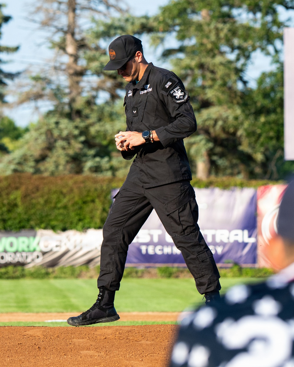 F-22 Demonstration Team crew chief throws the first pitch for the St. Cloud Rox