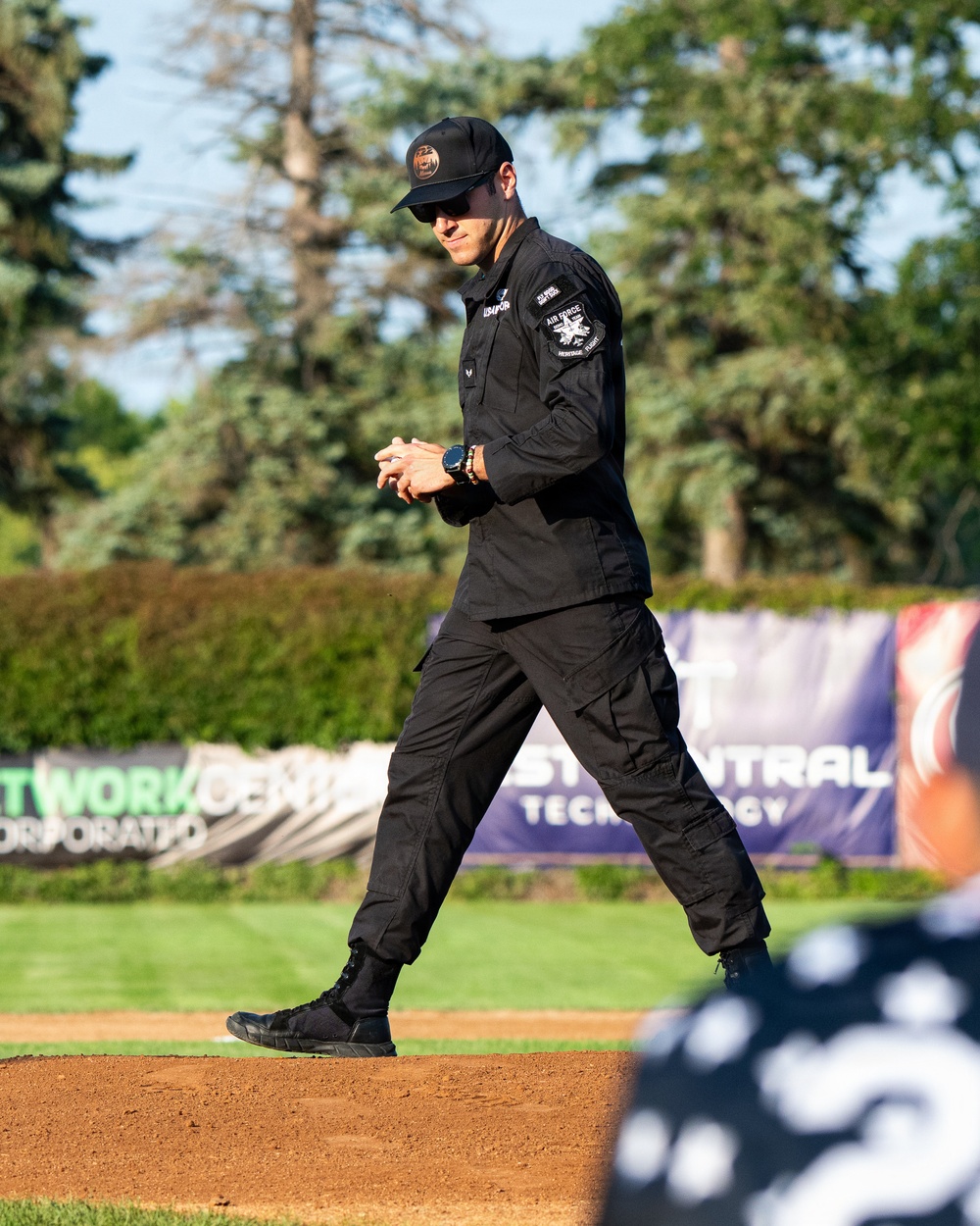 F-22 Demonstration Team crew chief throws the first pitch for the St. Cloud Rox