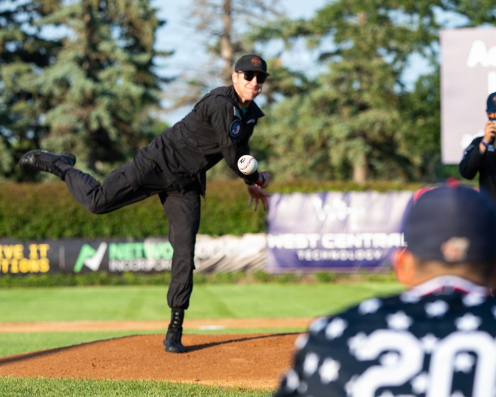 F-22 Demonstration Team crew chief throws the first pitch for the St. Cloud Rox