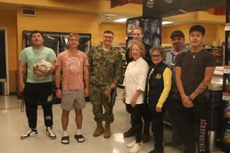 Navy Sailors Poses with Commissary Staff and Patrons at Military Grocery Store