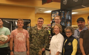 Navy Sailors Poses with Commissary Staff and Patrons at Military Grocery Store