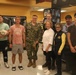 Navy Sailors Poses with Commissary Staff and Patrons at Military Grocery Store