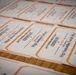 Multiple Certificates of Appreciation from Luis P. Matidan Middle School are spread across a wooden table. The certificates are awarded to military staff sergeants (SSgt), with visible names including Joshua Galvan, Jesse Hernandez, Selena Rios, Samantha Van De Riet, and others. The certificates feature an orange and black border design on white paper.