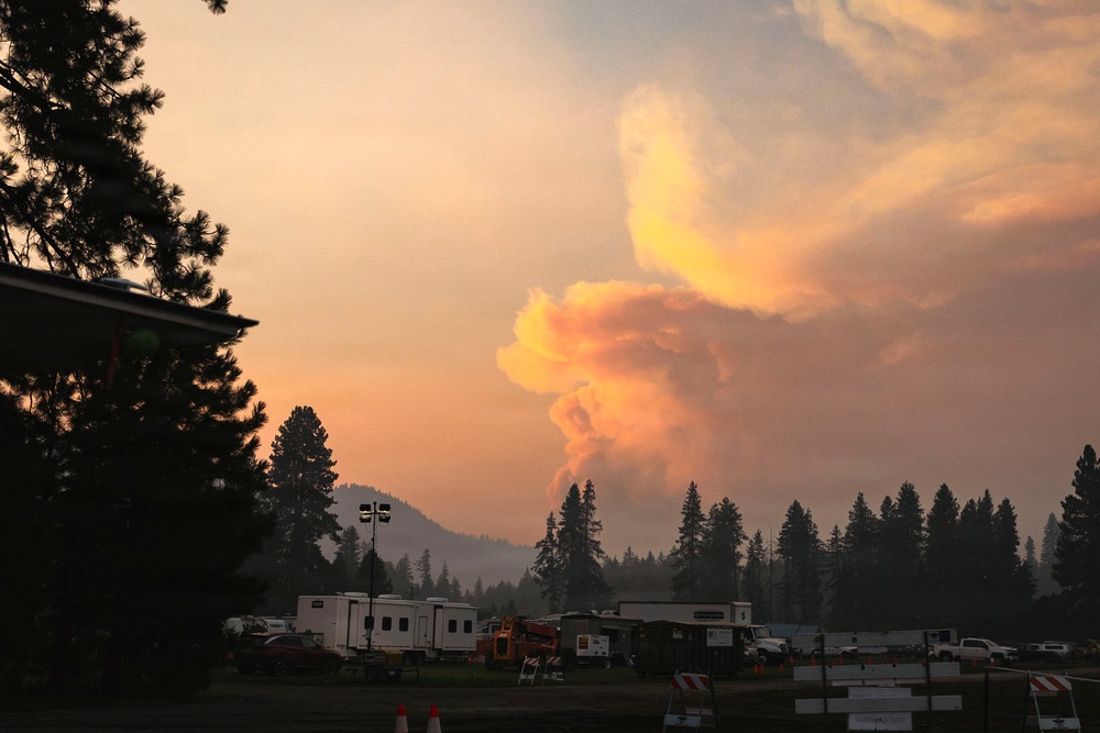 Pyrocumulus cloud rises over wildfire incident command post in Pacific Northwest forest