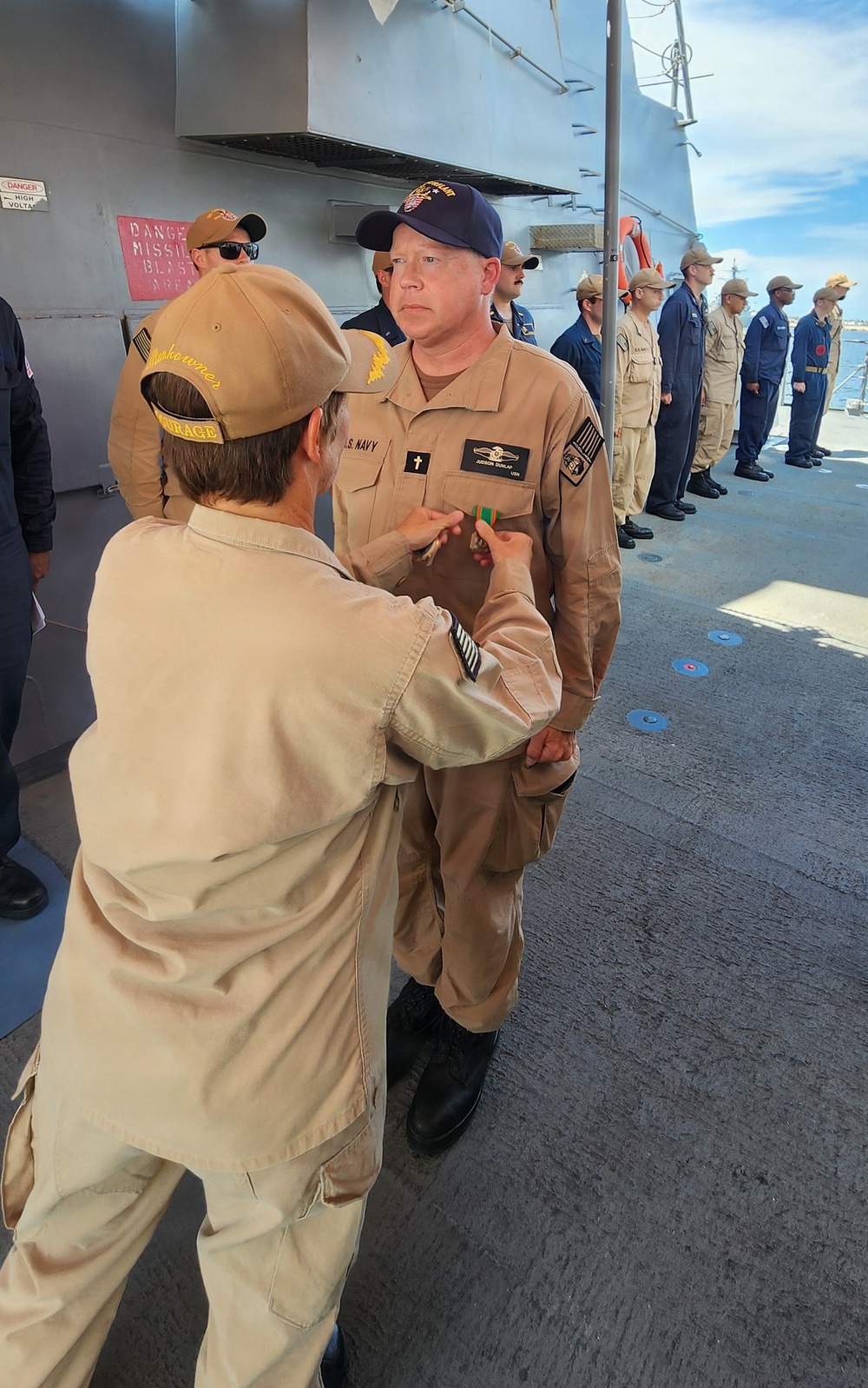 Chaplain Judson Dunlap is rung ashore having completed his assignment onboard USS Ted Stevens (DDG 128).