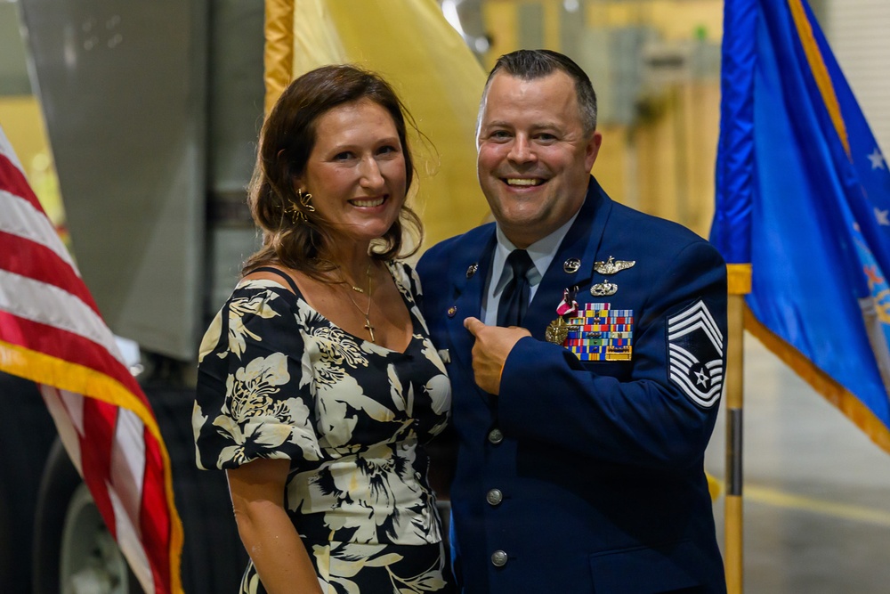 U.S. Air Force Chief Master Sergeant poses with spouse during military ceremony