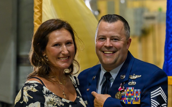 U.S. Air Force Chief Master Sergeant poses with spouse during military ceremony
