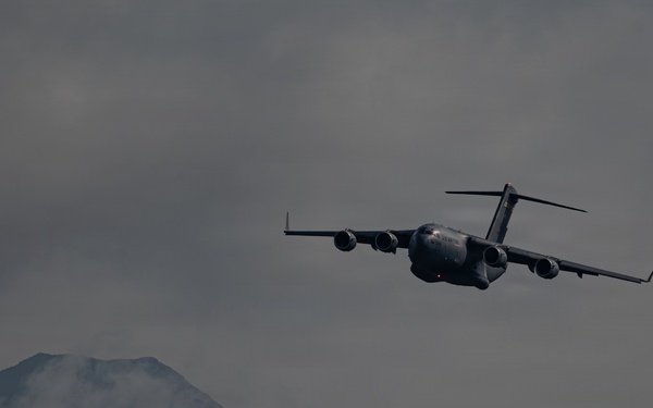 A C-17 Globemaster III aircraft performs an aerial demonstration during the Arctic Thunder Open House 2026