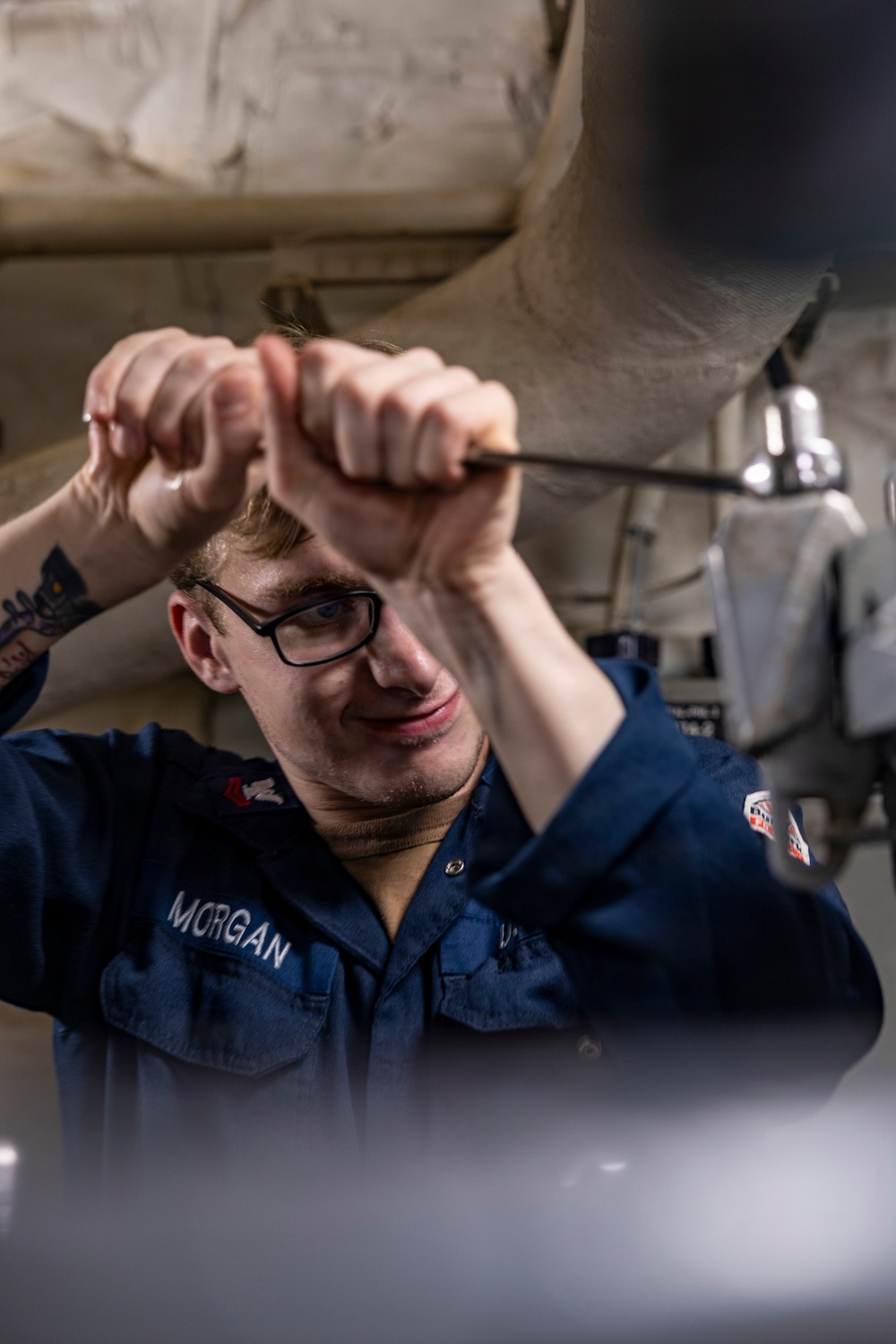 Sailors Conduct Routine Maintenance In Engine Room