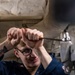 Sailors Conduct Routine Maintenance In Engine Room