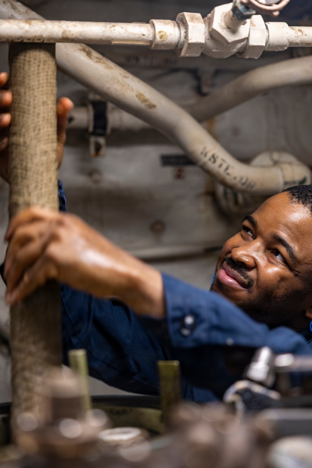 Sailors Conduct Routine Maintenance In Engine Room