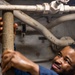 Sailors Conduct Routine Maintenance In Engine Room