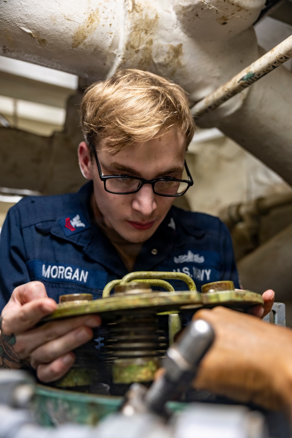 Sailors Conduct Routine Maintenance In Engine Room