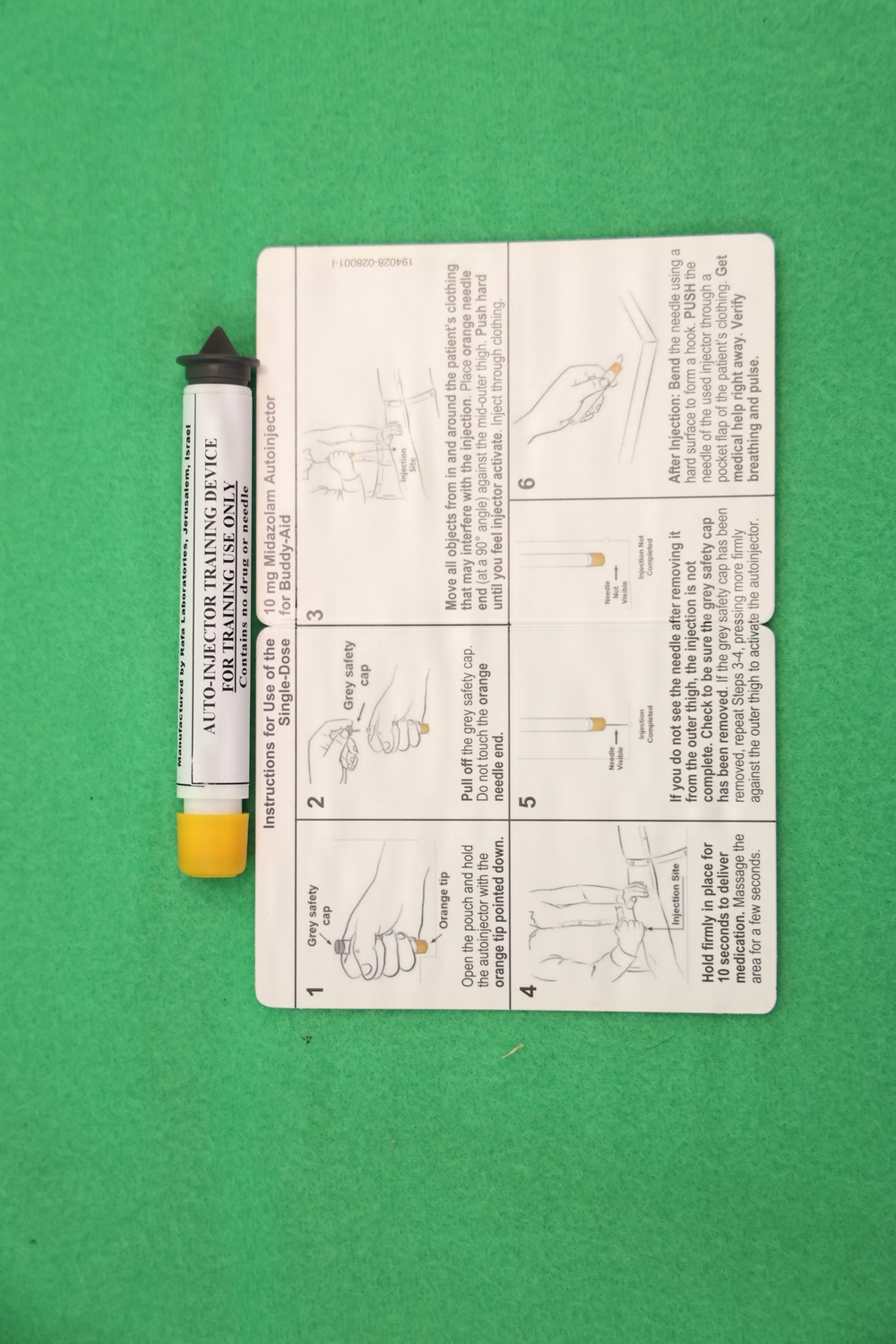The image shows an auto-injector training device alongside a six-step instruction card for a 10mg Midazolam Autoinjector (Buddy-Aid). The device is labeled 'AUTO-INJECTOR TRAINING DEVICE FOR TRAINING USE ONLY' and contains no drug or needle. It is manufactured by Rafa Laboratories, Jerusalem, Israel.