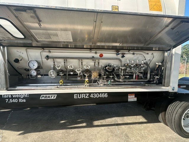 The image shows the open valve and plumbing compartment of a cryogenic or industrial tank trailer manufactured by Pratt, identified by unit number EURZ 430466 with a tare weight of 7,540 lbs. The compartment reveals an extensive array of valves, gauges, pipes, and fittings typical of a liquid gas or chemical transport tanker. The equipment appears to be in operational condition with the access panel fully open for inspection or servicing.