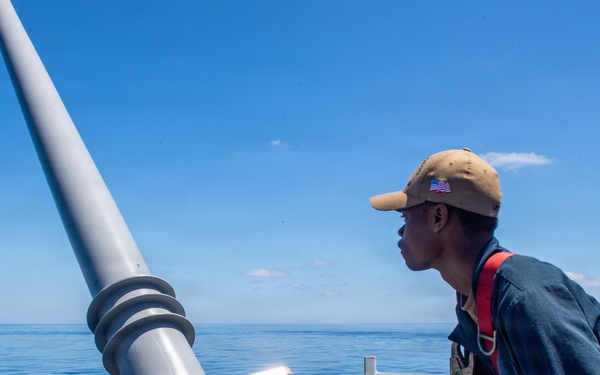 Sailor Works Equiptment At Sea