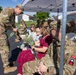 Soldier Hands Yellow Roses to Family