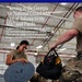 A promotional image for the Georgia Air National Guard's 165th Airlift Wing featuring two service members performing aircraft maintenance work inside a hangar. The image includes a quote from a member named Pardo about the value of serving in the Guard. The personnel appear to be working on an aircraft access panel or hatch.