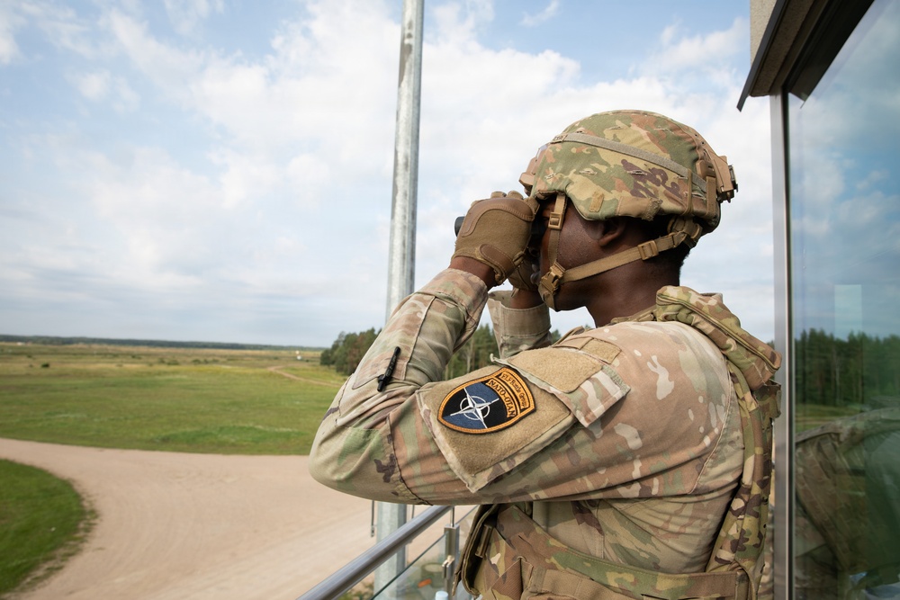 U.S. and British soldiers build interoperability as Paladins fire during range training